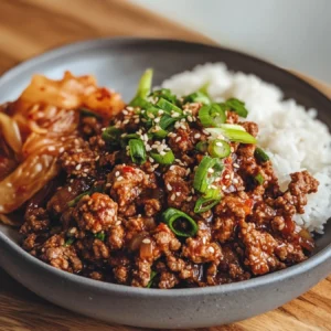 Ground beef bulgogi served with steamed rice and kimchi in a Korean dinner setting.